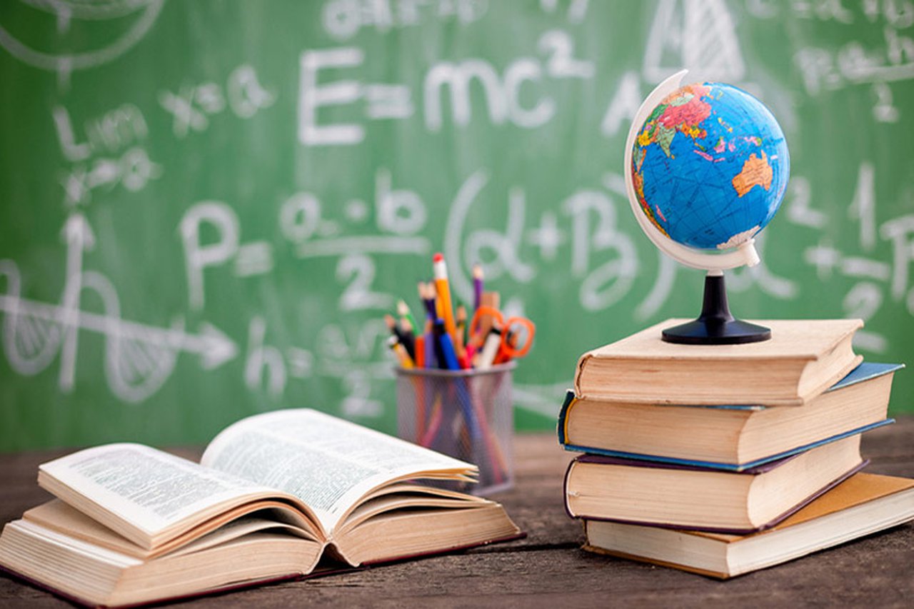 A world globe on top of a pile of books