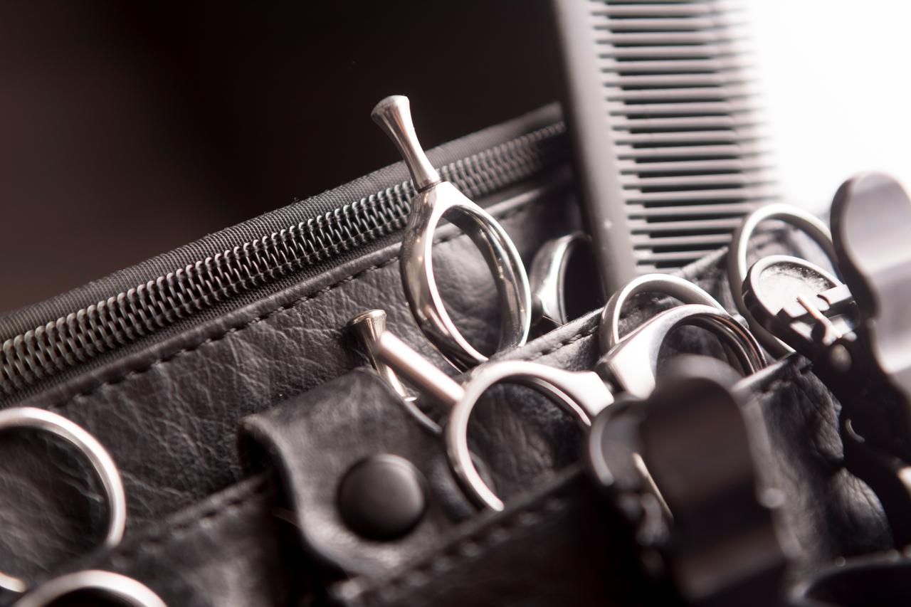 Hairdressing belt with hairdressing tools which includes scissors and combs