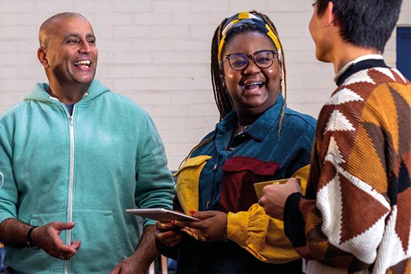 Group of people laughing and engaging in conversation during a Novus session.