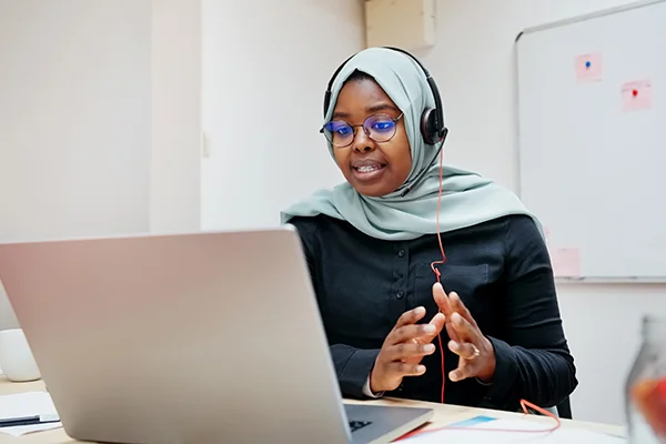 Woman using a laptop, representing access to the Thrive Learning CPD platform for continuous professional development.