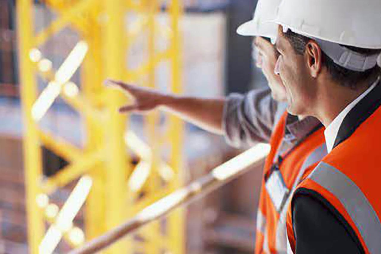 Two construction workers on site