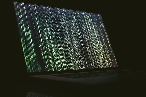 A laptop displaying lines of code