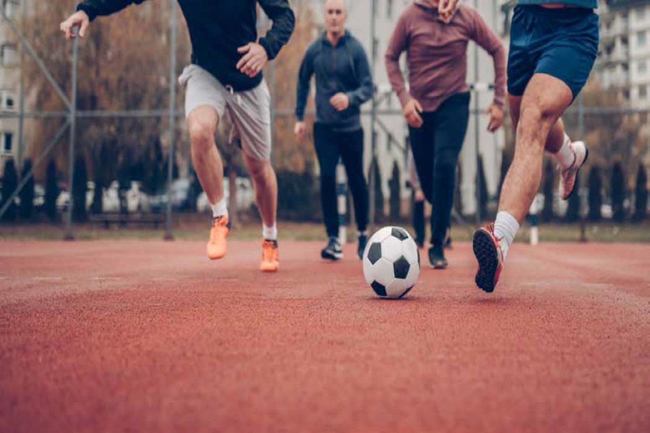 People playing football in a playground